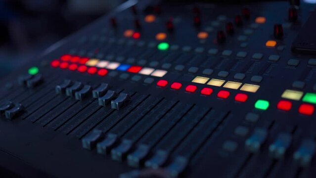 Professional audio mixing console. ​Mixer. Pro audio mixing board faders and knobs. Static shot of multi-track music recording equipment faders and sliders.	
