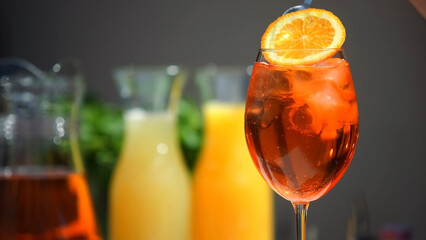 Champagne in an aperol spritz cocktail glass with orange slices. Vacation, summer, vacation, concept of luxury resort and delicious drinks