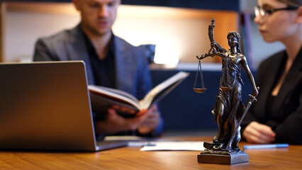 A lawyer meets with a new client. A young male lawyer in a suit sits at an office desk, shares legal advice, explains the inheritance process, tries to help. Legal advice concept - obrazy, fototapety, plakaty