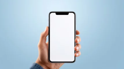 Poster Hand holding a smartphone with a blank white screen against a blue background, offering a clear display for a mockup or app presentation. © MP Studio
