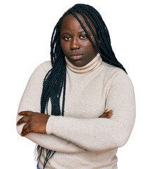 Young black woman with braids wearing casual winter sweater skeptic and nervous, disapproving expression on face with crossed arms. negative person.