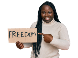 Young black woman with braids holding freedom banner smiling happy pointing with hand and finger