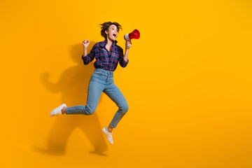Full size photo of attractive eccentric girl jumping scream in megaphone look empty space support...