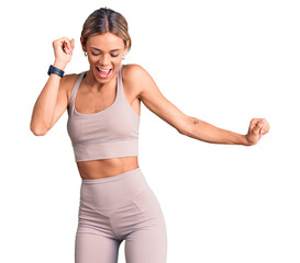 Fototapeta na wymiar Beautiful caucasian woman wearing sportswear dancing happy and cheerful, smiling moving casual and confident listening to music