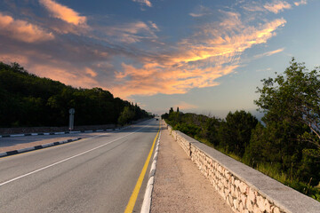 European Highway with markings in the mountains leading to the sea at dawn. Coast of the Black Sea.
