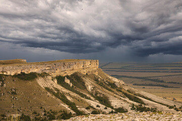 Mountain canyon in the dry season, against a stormy sky. White Rock, Crimea.