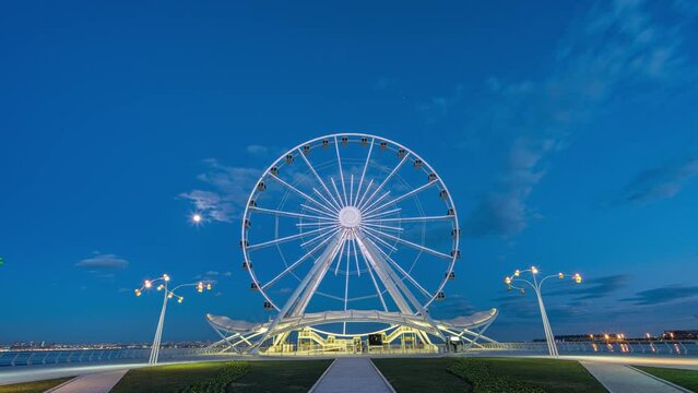 Ferris wheel silhouette at sunset beautiful clouds in the sky. Big round metal structure tall man made construction used for observation and amusement rides timelapse hyperlapse 4K Baku Azerbaijan