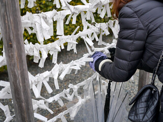 Tourists are tying prayer paper to make a wish.