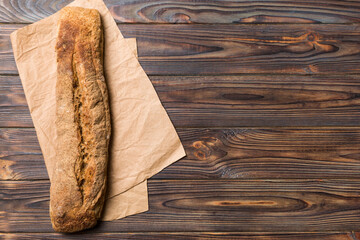 fresh crunchy french baguette on colored table. Top view Bakery products
