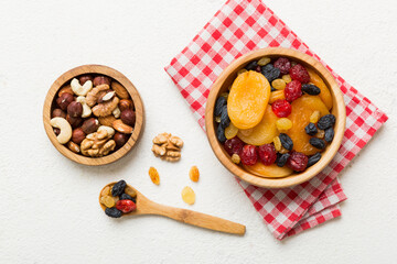 healthy snack: mixed nuts and dried fruits in bowl on table background, almond, pineapple, cranberry, cherry, apricot, cashew