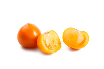 Whole and half of yellow tomato isolated on white background.