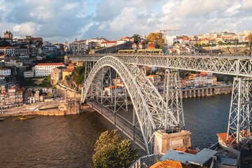 Panoramic view of the city of Oporto during sunset. Porto skyline. Magnificent sunset over downtown Porto and the Douro river, Portugal. The Dom Luis I bridge is a popular tourist spot.