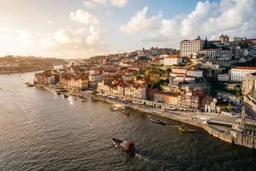 Foto auf Acrylglas Panoramic view of the city of Oporto during sunset. Porto skyline. Magnificent sunset over downtown Porto and the Douro river, Portugal. The Dom Luis I bridge is a popular tourist spot. © ikuday