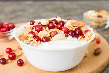 Healthy breakfast food with granola, yogurt, fruits and nuts. Dessert parfait with dried fruits for breakfast