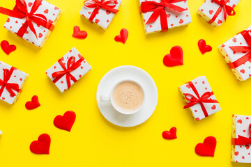 Mug coffee and gift box on colored background. Flat lay composition. Holiday concept