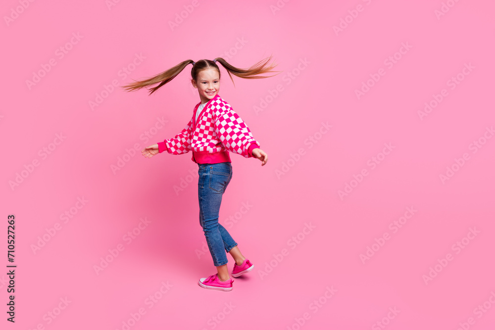 Canvas Prints Full size photo of positive schoolgirl with tails dressed knit cardigan turning around near empty space isolated on pink color background