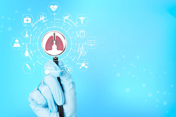 Doctor's hand in a glove holds a stethoscope with the anatomical shape of healthy human lungs, and...