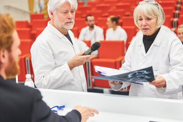 Doctors discussing over x-ray during medical conference event