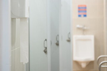 Selective focus toilet tissue paper in white box for cleaning hand on white wall background.