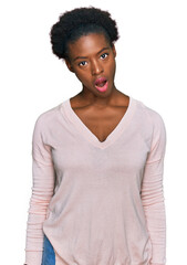 Young african american girl wearing casual clothes in shock face, looking skeptical and sarcastic, surprised with open mouth