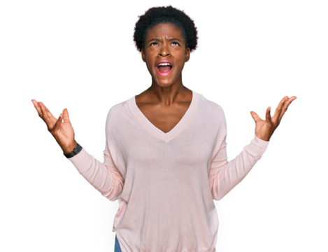 Young african american girl wearing casual clothes crazy and mad shouting and yelling with aggressive expression and arms raised. frustration concept.