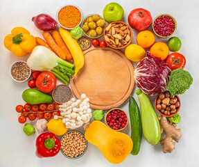 Healthy food background. fruits, vegetables, seeds, superfood, cereal and empty cutting board. top view