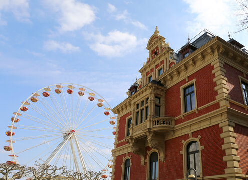 Ferris Wheel by  Beautiful German Architecture with Cloudy Sky in Mainz, Germany