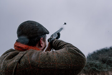 Hunter shooting pheasant