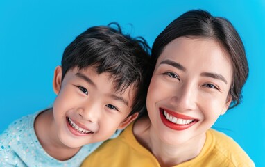 happy Asian mother and kid smiling and wearing bright clothes