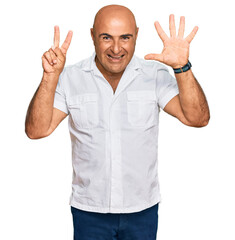 Mature middle east man with mustache wearing casual white shirt showing and pointing up with fingers number seven while smiling confident and happy.