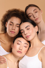 Fototapeta premium Beautiful young women with healthy skin on beige background