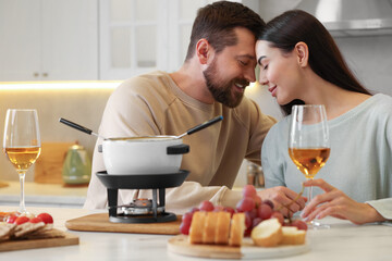 Romantic date with fondue. Affectionate couple enjoying each other at home