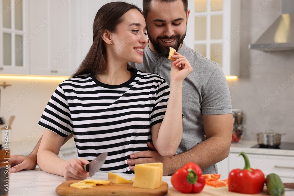 Wall mural lovely young couple cooking together in kitchen