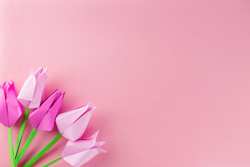 Tulips made of colored paper on a pink background, handmade, copy space. Mother's day, women's day concept.