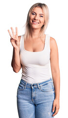 Fototapeta premium Young beautiful blonde woman wearing casual sleeveless t-shirt showing and pointing up with fingers number three while smiling confident and happy.