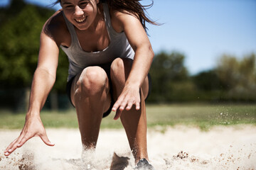 Woman, sand and long jump athlete outdoor training for endurance competition, skill or performance....