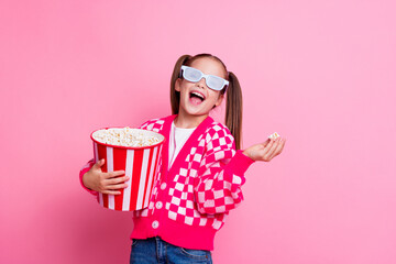 Photo of cute cheerful girl wear trendy clothes eat tasty pop corn watching cartoon film empty...