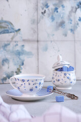 Matcha blue tea. Blue tea in a white cup. Matcha blue tea. A white cup with blue flowers. Cubes of blue sugar. Expensive Chinese tea. A natural antioxidant.