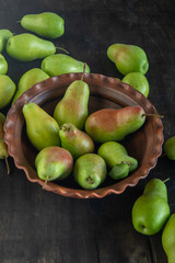 Parisian pear variety. Fruits on the table. Autumn harvest. Pears top view background. Green yellow red color pear. Vitamin vegan food.