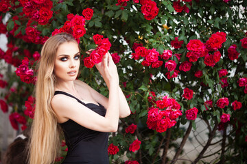 Young Female Black Top Windy Wavy Hair Portrait in Rose Flower Garden Golden Hour Head Turned Curious Looking