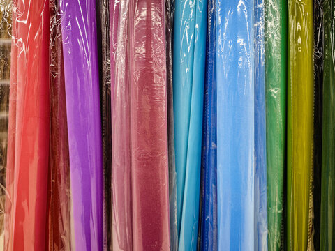 Multi-colored fabrics on the store counter background