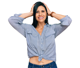 Young caucasian woman wearing casual clothes crazy and scared with hands on head, afraid and surprised of shock with open mouth