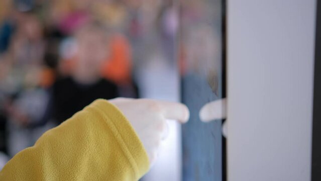 Woman choosing food via self-service machine at fast food restaurant. Girl using touch terminal im makes a quick order through the self-service. Person swipes the screen making an order.4K