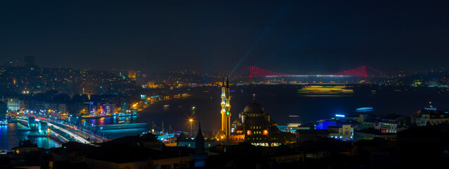 Fototapeta na wymiar Night Istanbul view, Bosphorus Bridge (15 July Martyrs Bridge), Eminönü district sea view and new mosque