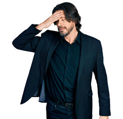 Middle age caucasian man wearing business clothes surprised with hand on head for mistake, remember...