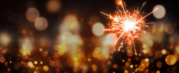 happy new year, sylvester, New Year's Eve 2025 party event celebration holiday greeting card - Closeup of sparkling sparklers and bokeh lights in the background