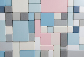 Shades of gray and light blue color samples set against a natural white backdrop, surrounded by pink, white, and blue-gray cubes in a shallow depth of field.