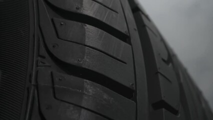 Tire Smokes While Drifting. The spinning wheel rubs against the asphalt and creates a cloud of white smoke on a black background