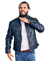 Young arab man wearing casual leather jacket cutting throat with hand as knife, threaten aggression...