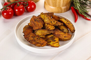 Golden baked potato Idaho with spices